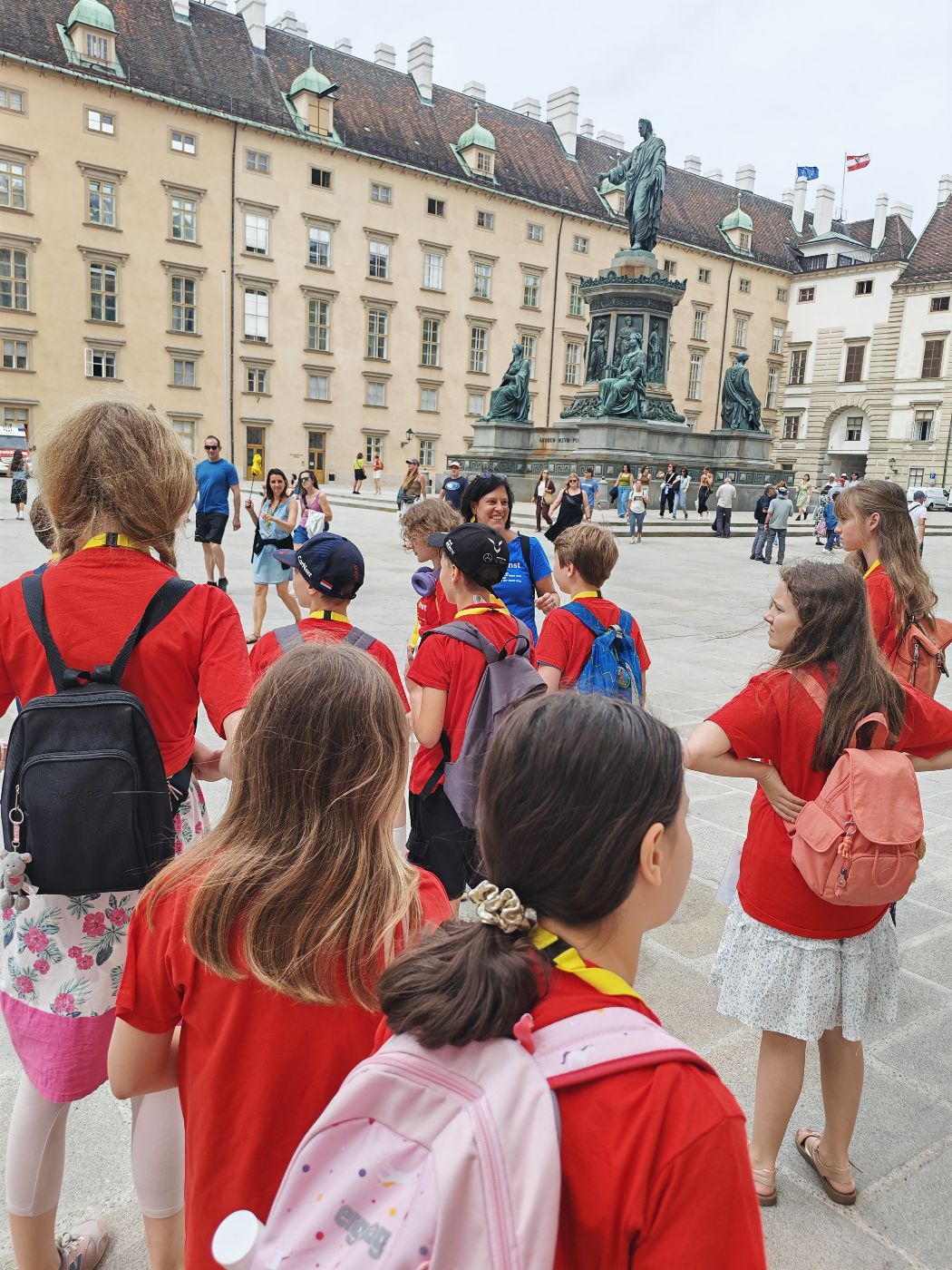 eine Gruppe von Kindern steht vor dem Denkmal von Kaiser Franz im Burghof in Wien