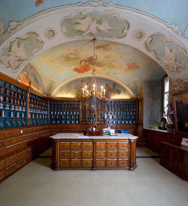 Blick in eine mit Stuck und historischen Möbeln verzierte alte Apotheke